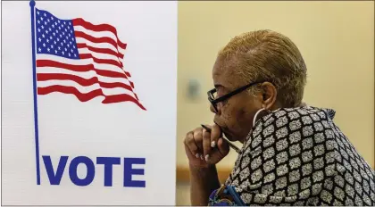  ?? CHRIS MACHIAN — VIA THE ASSOCIATED PRESS ?? Larnisha Dortch fills out her ballot during Nebraska’s primary election on Tuesday in Bellevue. Former President Donald Trump faces another test of the power of his endorsemen­ts in Nebraska.