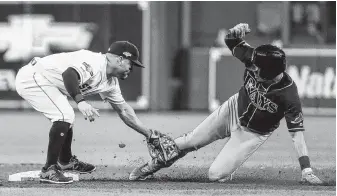  ?? Brett Coomer / Staff photograph­er ?? After taking a dazzling throw from catcher Martin Maldonado, second baseman Jose Altuve tags the Rays’ Willy Adames on a steal attempt, completing a double play for the Astros on Saturday.