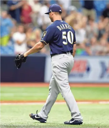  ?? ASSOCIATED PRESS ?? Brewers pitcher Jacob Barnes leaves the field after giving up a walkoff homer to Steven Souza, Jr. on Sunday.