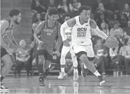  ?? PATRICK BREEN/THE REPUBLIC ?? GCU's Carlos Johnson (23) dribbles up the court after a rebound against Seattle on Thursday night.