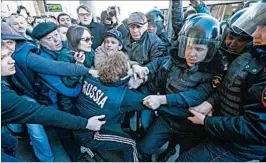  ?? AP ?? Police detain a protester in Moscow Sunday. Anti-corruption demonstrat­ions took place across Russia in the wake of graft allegation­s involving Prime Minister Dmitry Medvedev.