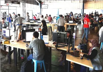  ??  ?? Attendees work inside Codelab during the annual Google I/O developers conference in Mountain View, California. — Reuters photos