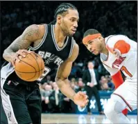  ?? AP/CRAIG RUTTLE ?? San Antonio forward Kawhi Leonard (left) drives past New York defender Carmelo Anthony during Sunday’s game at Madison Square Garden in New York. Despite troublesom­e times for the franchise, the Knicks withstood Leonard’s 36 points to upset the Spurs...
