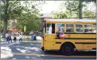  ?? Tyler Sizemore / Hearst Connecticu­t Media file photo ?? A school bus picks up students at Old Greenwich School on Sept. 23, 2020.