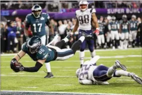  ?? FRANK FRANKLIN II - AP ?? Philadelph­ia Eagles tight end Zach Ertz (86) dives into the end zone over New England Patriots free safety Devin McCourty (32) for the game-winning touchdown during the second half of Super Bowl 52.