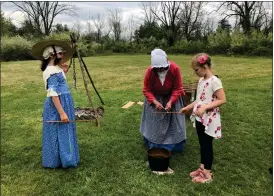  ?? PHOTO COURTESY OF DANIEL BOONE HOMESTEAD ASSOCIATES ?? Children’s Day features hands-on activities and demonstrat­ions at the Daniel Boone Homestead in Exeter Township on May 5from 12to 4p.m., including textile processing, candle dipping, quill pen writing and butter making.