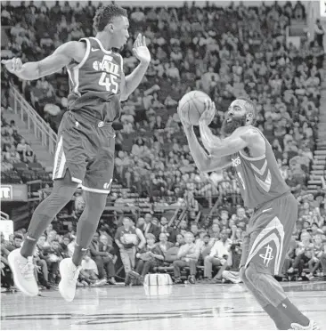  ?? Marie D. De Jesús / Houston Chronicle ?? Rockets guard James Harden, right, shoots the ball under pressure from Utah guard Donovan Mitchell. Harden finished with a career-high 56 points — one point shy of Calvin Murphy’s franchise record.