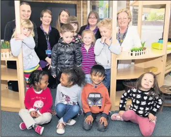  ??  ?? Pictured: Radmoor Day Nursery manager Veronica Savill (far right) is joined by staff and children at their new venue in Radmoor Road.