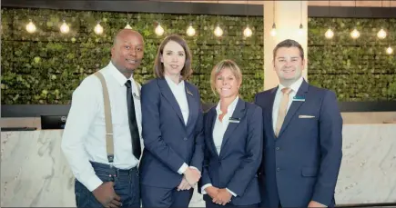  ??  ?? TEAM WORK: In the reception area with the backdrop of a living wall comprising more than 3 500 plants are restaurant manager Winson Nyoni, hotel general manager Walda Meyer, executive housekeepe­r Michelle Presting and front office manager Michael...