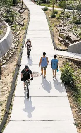  ?? GABRIELA CAMPOS/THE NEW MEXICAN ?? Bicyclists and walkers enjoy the Acequia Trail on Wednesday afternoon. Following a report of a rape in early July along the trail, concerns about safety have been raised by some residents.