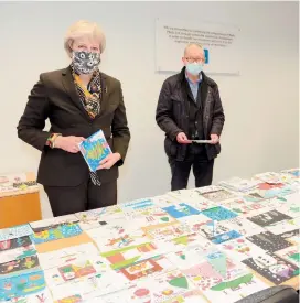  ?? ?? Theresa May and her husband, Sir Philip, judging last year’s Christmas card competitio­n in the ‘Tiser offices. Ref:133142-13