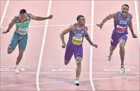  ?? AP ?? ■ Christian Coleman of the US crosses the line first in the 100 metres final, with compatriot Justin Gatlin second, in the World Athletics Championsh­ips in Doha on Saturday.