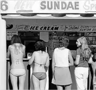  ??  ?? SWEET SUNDAY: Holiday-makers line up for ice cream at Burleigh Heads.