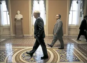  ??  ?? Senate Majority Leader Mitch McConnell, R-Ky., walks to a meeting of Republican senators where a new version of their health care bill was scheduled to be released Thursday at the U.S. Capitol in Washington. The latest version of the proposal aims to...