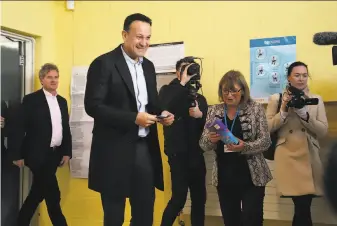  ?? Damien Storan / Press Associatio­n ?? Prime Minister Leo Varadkar, Ireland’s first openly gay leader, casts his ballot in Castleknoc­k. His Fine Gael party was tied with the Fianna Fail and Sinn Fein parties, according to a poll.