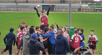  ??  ?? Pres Athenry junior captain Shea Hennessy celebrates winning the developmen­t cup