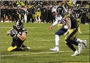  ?? DON WRIGHT / AP ?? Steelers tight end Jesse James (81) thought he had a TD on this play, but a replay showed the ball hitting the ground as he lunged into the end zone.