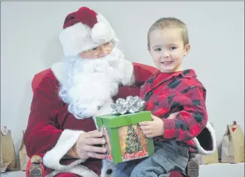  ?? KIRK STARRATT ?? Four-year-old Bentley Taylor of Black Rock was all smiles after receiving a gift from Santa Claus at the children’s Christmas party in Halls Harbour.