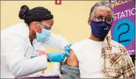  ?? Yehyun Kim / CTMirror.org ?? Stanwyck Cromwell, of Bloomfield, right, receives the first dose of COVID-19 vaccine at the First Cathedral Church in Bloomfield.