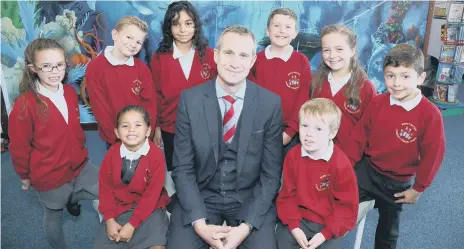  ??  ?? Mr Ratchford with some pupils