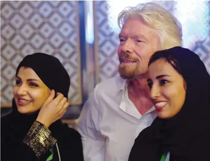  ??  ?? British businessma­n and founder of Virgin Group Richard Branson poses for a picture with Saudi women during the Future Investment Initiative conference in Riyadh. (AFP)