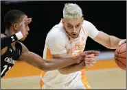  ?? (AP/Knoxville News Sentinel/Calvin Mattheis) ?? Tennessee guard Santiago Vescovi (right) dribbles Saturday while being guarded by Cincinnati guard Mika Adams-Woods during the No. 12 Volunteers’ 65-56 victory in Knoxville, Tenn.