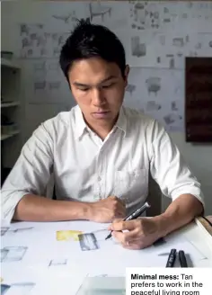  ??  ?? Minimal mess: Tan prefers to work in the peaceful living room of his home, where he posts sketches of his works both past and present along the walls for inspiratio­n