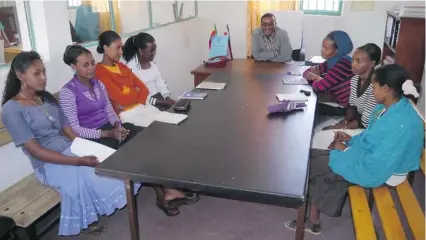  ??  ?? At the head of the table, Ato Atamo, director of the health centre in Fiche, North Shoa, in the Oromiya region of Ethiopia, meets with agroup of health extension workers.