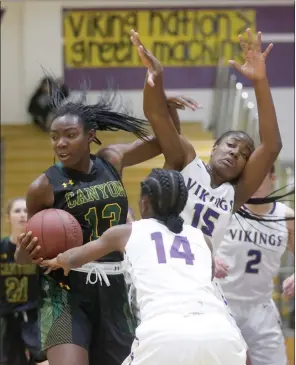  ??  ?? Nikolas /The Samuels Signal (See additional photos on signalscv.com) Canyon’s Selasi Mawugbe (13) snags a rebound during an away game against Valencia on Tuesday. The Cowboys beat the Vikings 58-33.