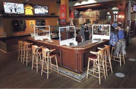  ?? FRED SQUILLANTE/THE COLUMBUS DISPATCH ?? Businesses that rely on events at Nationwide Arena and the Greater Columbus Convention Center are struggling. Bartender Brendon Fabian, left, talks with customers Chyanne Lindaman and Craig Padleckas on a slow afternoon at Barley's Brewing Company on Friday.