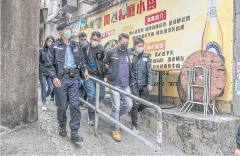  ?? NYT ?? Police escort Andrew Wan, a pro-democracy politician who recently resigned from Hong Kong’s legislatur­e, in Hong Kong yesterday.