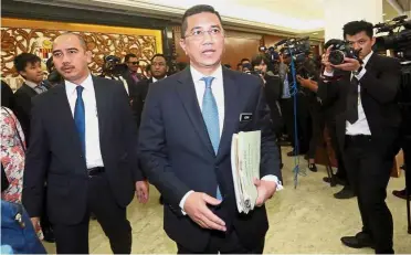  ??  ?? Briefing the media: Azmin walking out of the Dewan Rakyat.