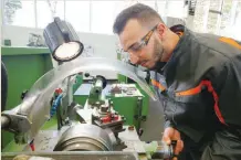  ?? — Reuters ?? Mohammad al Halabi, a 22-year-old refugee from Syria works with a miller at the training workshop of Ford Motor Co in Cologne. Al Halabi is one of 24 trainees of Ford Germany’s so-called EQ qualificat­ion programme to integrate new employees in a booming labour market.