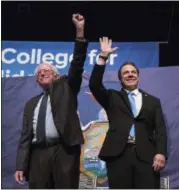  ?? MARY ALTAFFER — THE ASSOCIATED PRESS ?? In this file photo, New York Gov. Andrew Cuomo, right and Vermont Sen. Bernie Sanders wave at the audience as they arrive on stage at an event at LaGuardia Community College, in New York for the announceme­nt of Cuomo’s proposal for free tuition at...