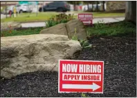 ?? (AP/Keith Srakocic) ?? Signs posted outside a gas station last month direct potential employees in Cranberry Township, Pa. The number of Americans applying for unemployme­nt benefits dropped last week.