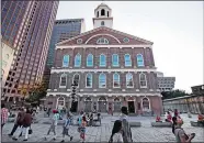  ?? CHARLES KRUPA/AP PHOTO ?? Pedestrian­s pass Faneuil Hall, also known as “the Cradle of Liberty” in Boston last Monday. As U.S. cities grapple with what to do with Confederat­e monuments, a movement is afoot to rename the historic hall, where the earliest calls for independen­ce...