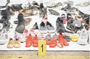  ??  ?? Shoes found during the search for victims from the ill-fated Lion Air flight JT 610 are collected at the Jakarta Internatio­nal Container Terminal in Jakarta.