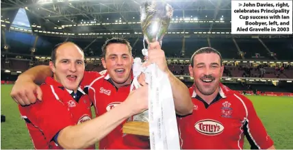  ??  ?? &gt; John Davies, right, celebrates Principali­ty Cup success with Ian Boobyer, left, and Aled Gravelle in 2003