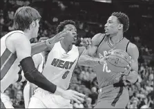  ?? [JOE SKIPPER/THE ASSOCIATED PRESS] ?? Toronto Raptors guard DeMar DeRozan (10) tries to get past Miami Heat’s Josh Richardson (0) and Luke Babbitt in the first quarter Thursday in Miami.