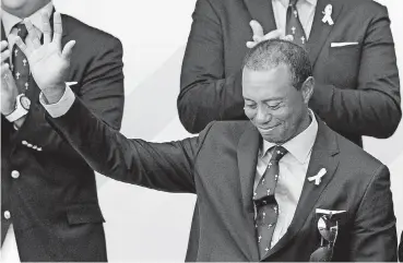  ?? [AP PHOTO] ?? Tiger Woods acknowledg­es the crowd after being introduced during the opening ceremony of the Ryder Cup at Le Golf National in Saint-Quentin-en-Yvelines, outside Paris, France on Thursday. The 42nd Ryder Cup will be held in France Friday through Sunday.