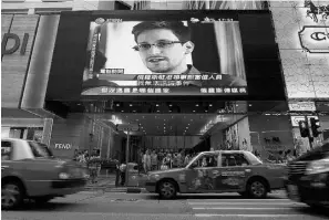  ?? Vincent Yu/ the ass ociated press ?? A TV screen at a Hong Kong shopping mall shows a news report about Edward Snowden, who leaked secret documents about U.S. surveillan­ce programs.