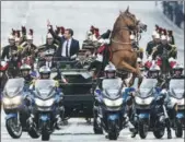  ?? MICHEL EULER / AGENCE FRANCE-PRESSE ?? A horse rears as new French President Emmanuel Macron parades on the Champs Elysees avenue on Sunday in Paris.