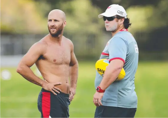  ?? Picture: BRETT COSTELLO ?? Jarrad McVeigh (left) with now Suns coach Stuart Dew during his time as an assistant at the Sydney Swans.