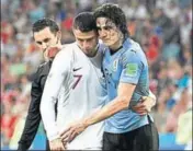  ?? AFP ?? ■ Ronaldo helps Edinson Cavani (right) off the pitch.