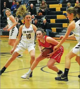  ?? DEBBY HIGH — FOR DIGITAL FIRST MEDIA ?? Souderton’s Megan Bealer is defended by Central Bucks West’s Olivia Irons (10) and Julia Kreider (55) Tuesday night.