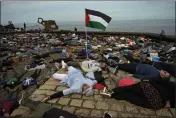  ?? ALVARO BARRIENTOS — THE ASSOCIATED PRESS ?? Pro-Palestinia­n demonstrat­ors lie on the ground as they protest against Israeli attacks on Gaza, in San Sebastian, northern Spain, on Sunday.