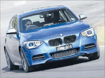  ??  ?? Fast hatch: The M135i sports a 3.0-litre turbocharg­ed six-cylinder engine.