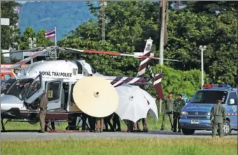  ?? ATHIT PERAWONGME­THA / REUTERS ?? One of the rescued boys is moved under large umbrellas from a Royal Thai Police helicopter to a waiting ambulance at a military airport in Chiang Rai, northern Thailand, on Monday.