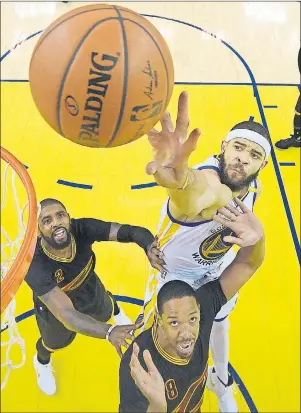  ?? AP PHOTO ?? Golden State Warriors centre JaVale McGee, top, reaches for the ball over Cleveland Cavaliers guard Kyrie Irving, left, and forward Channing Frye Sunday during Game 2 of the NBA Finals.