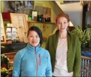  ??  ?? Owner Peicha Chang and floral arranger Kathryn Hedley stand in the customer area of Falls Flowers.